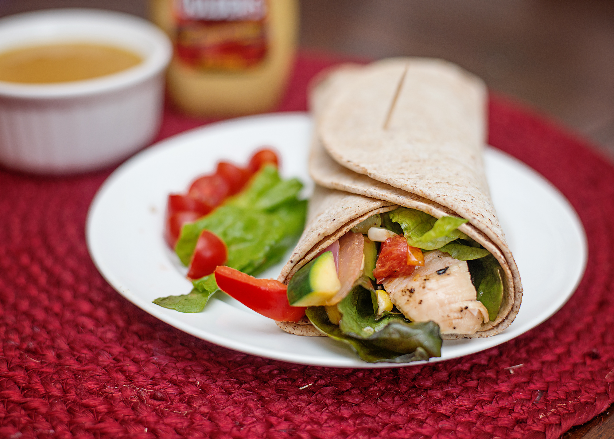 Easy weeknight dinners – rotisserie chicken wrap with lettuce and tomato in tortilla
